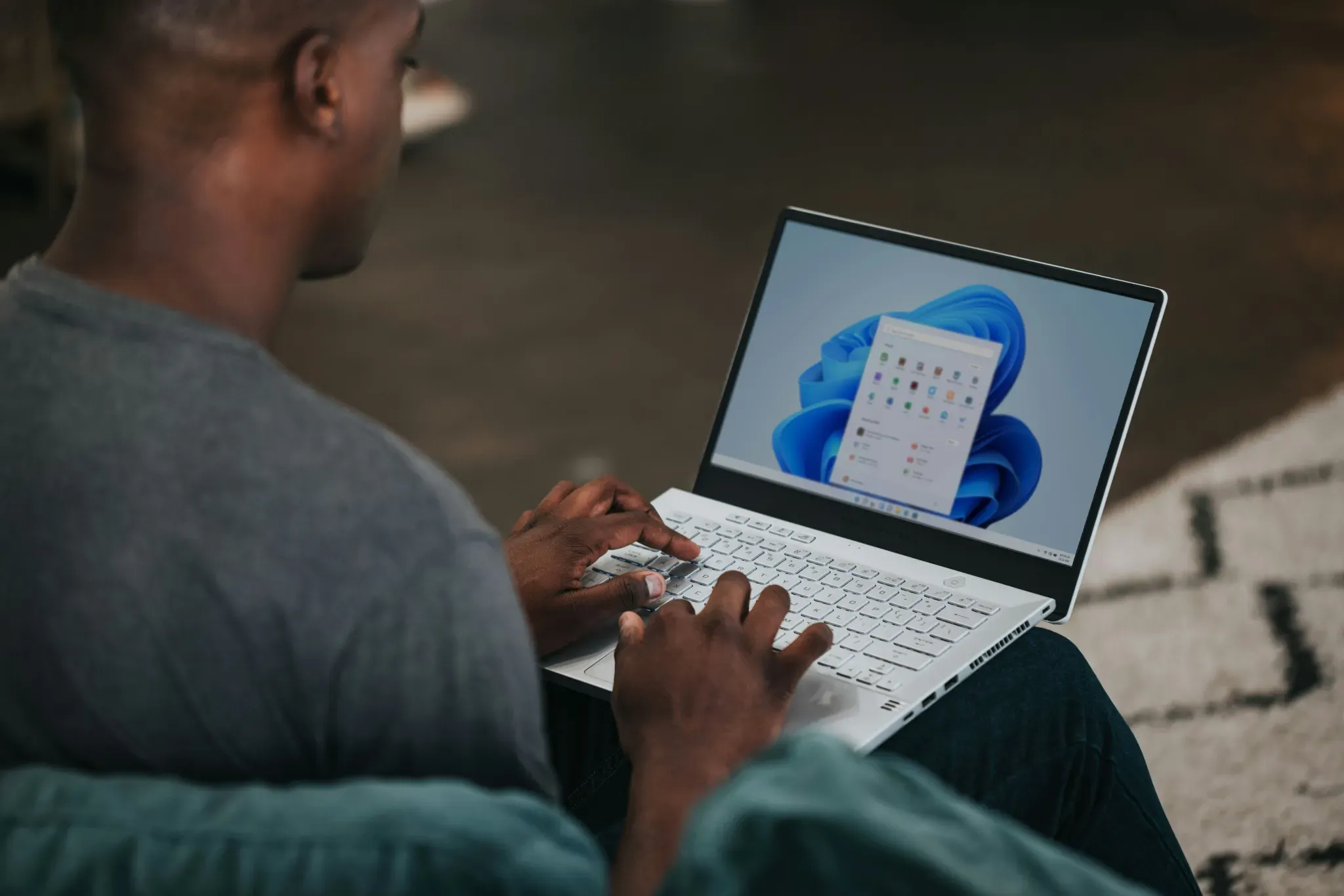 Person using a Windows laptop with apps displayed on screen